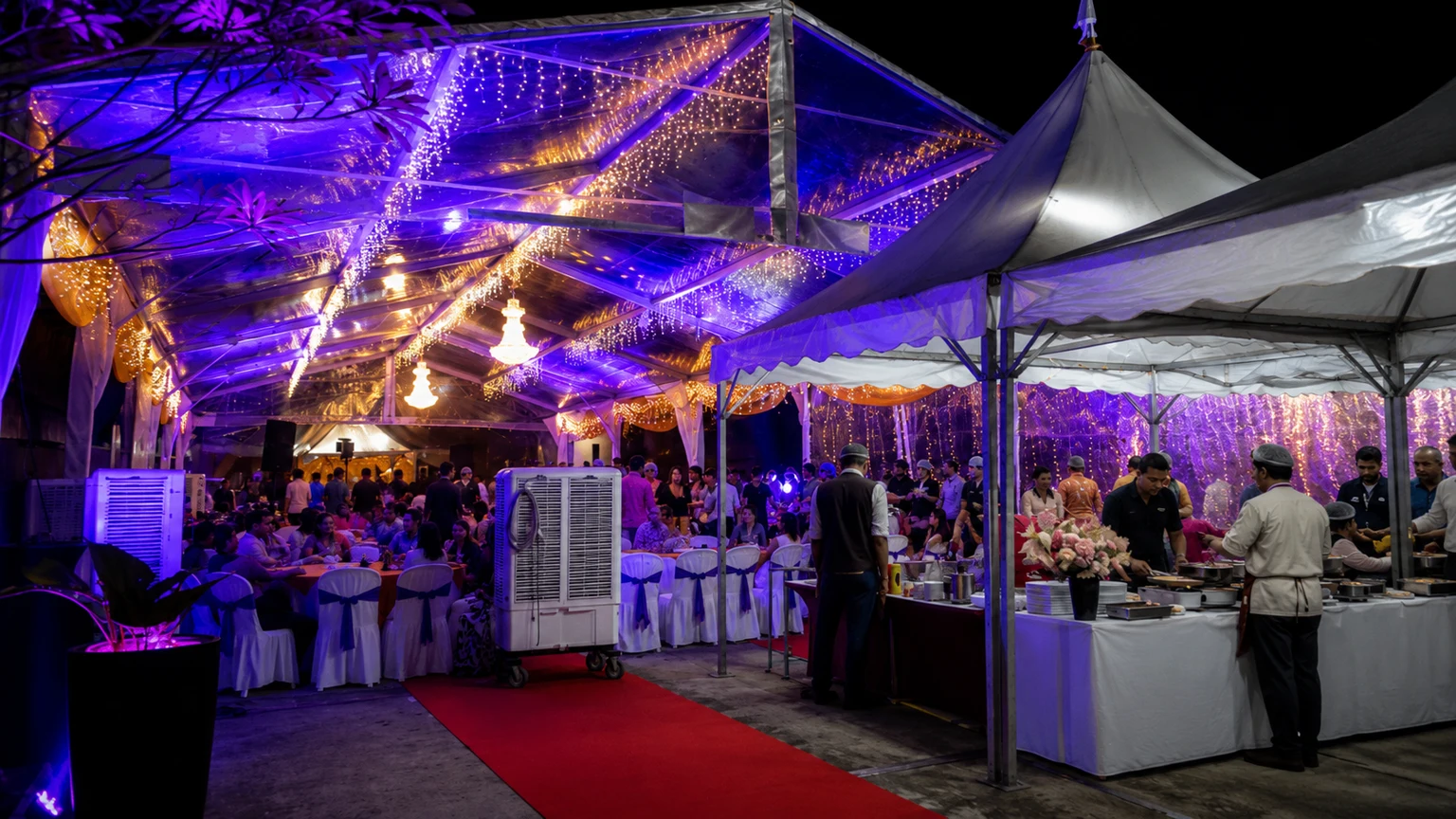Company dinner setup under transparent marquee with purple lighting, buffet service counters, red carpet, guest seating, air cooler and warm event lights